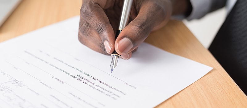 person signing a document
