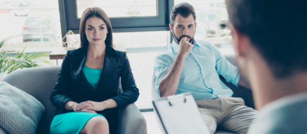 unhappy couple talking to divorce lawyer