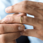 Man removing a wedding ring