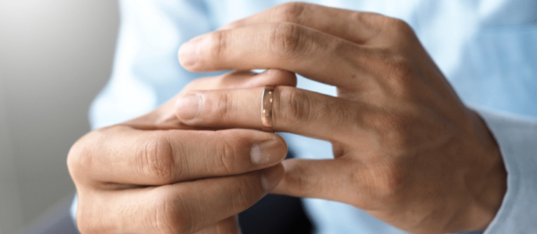 Man removing a wedding ring