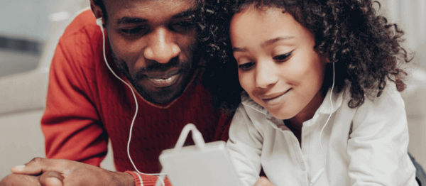 Father and Daughter watching Ipad together