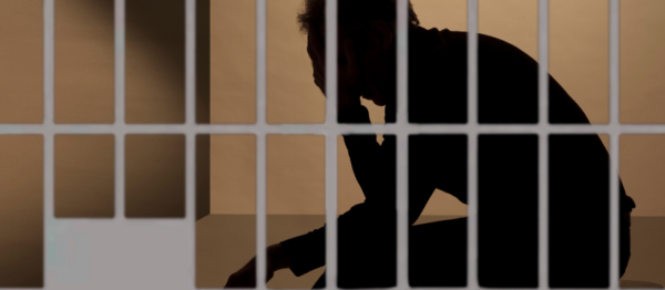 Silhouette Man behind bars