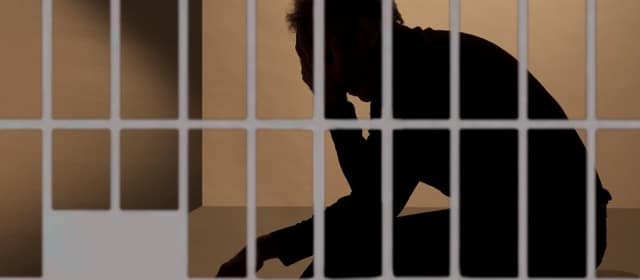 Silhouette Man behind bars