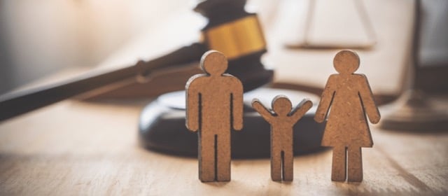 Wooden figure family set with child and parents illustrating termination of parental rights